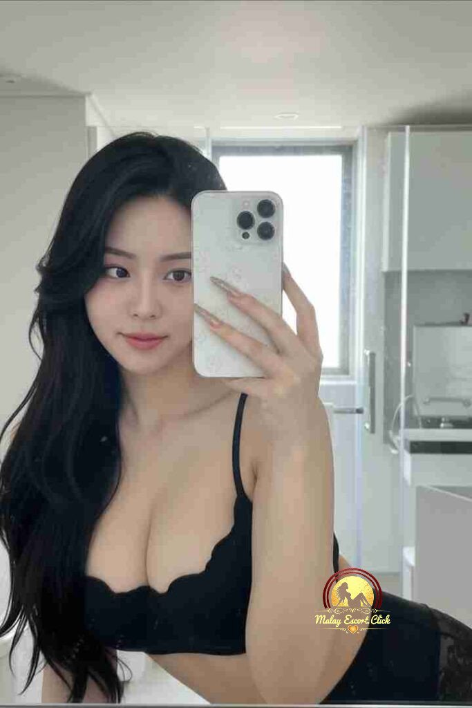 Beautiful Asian woman in black lingerie taking a selfie in a modern apartment.