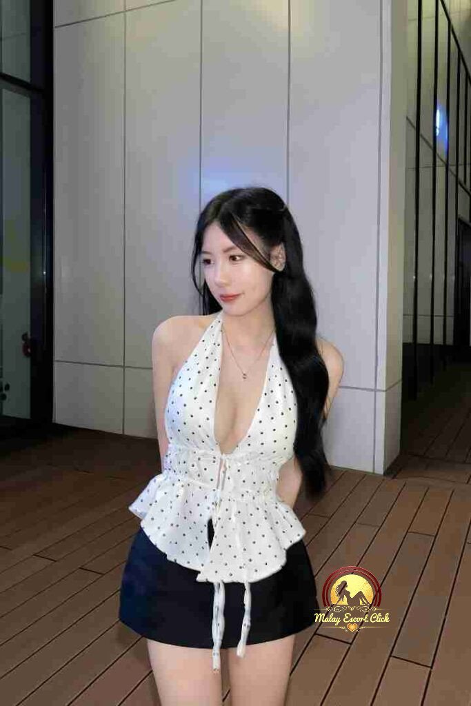 Attractive Asian woman in polka dot halter top and shorts.