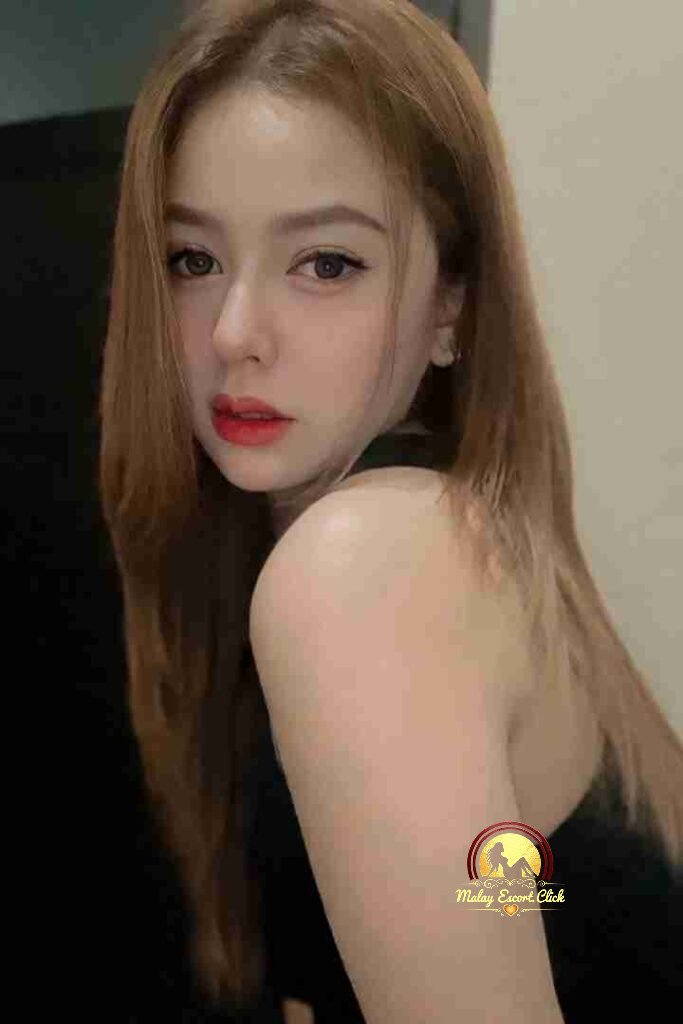 Malay Escort Girl Woman in hijab and mask wearing a revealing white shirt.