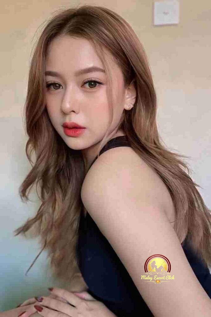 Malay Escort Girl Woman in hijab and mask wearing a revealing white shirt.