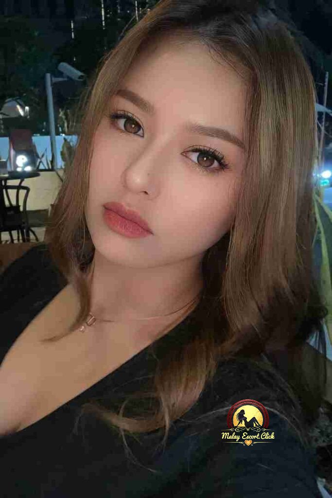 Malay Escort Girl Woman in hijab and mask wearing a revealing white shirt.