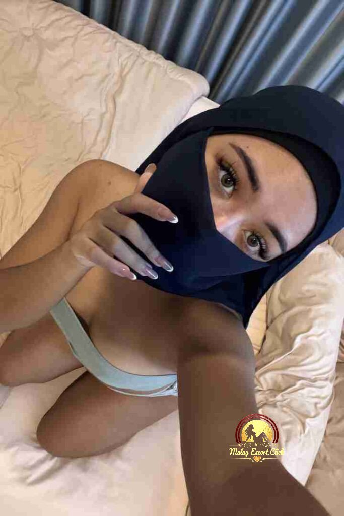 Malay Escort Girl Woman in hijab and mask revealing cleavage.