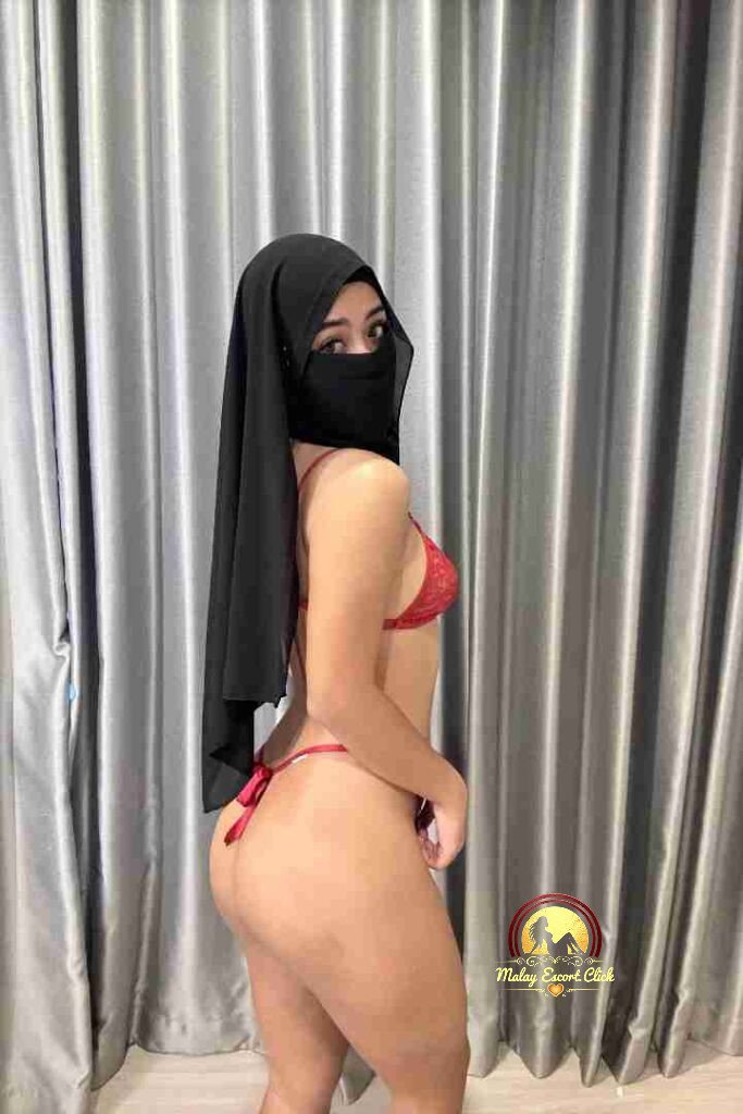Malay Escort Girl Woman in hijab and mask revealing cleavage.