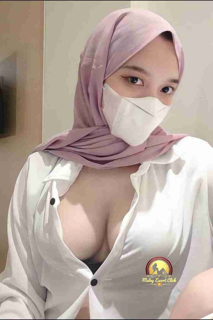 Malay Escort Girl Woman in anime shirt and lingerie kneeling indoors.