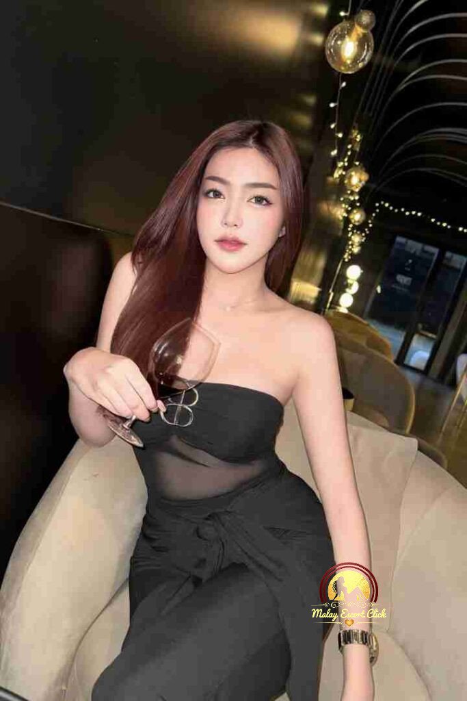 Malay Escort Girl Attractive Asian woman in a camisole top.