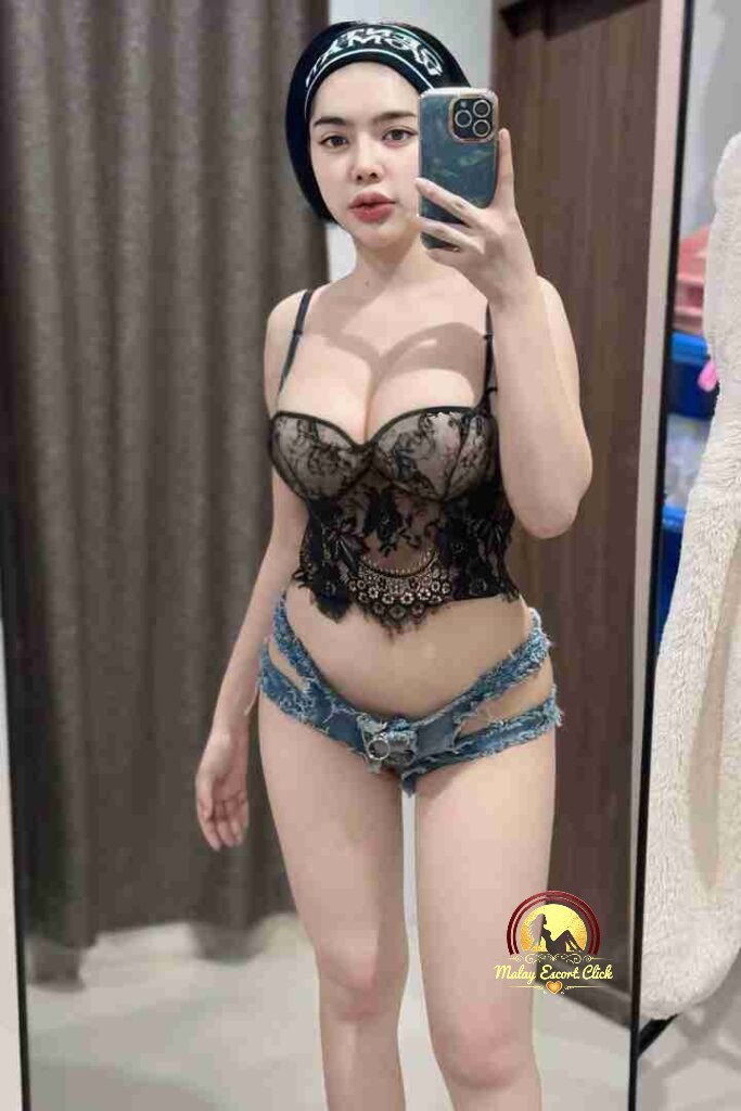 Woman in lingerie takes mirror selfie with phone in hand.